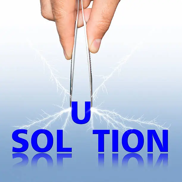 Photo of Hand with tweezers and word solution