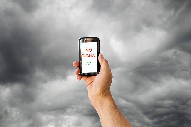 no signal with this stormy sky hand with a phone searching for signal with a stormy sky  no signal stock pictures, royalty-free photos & images