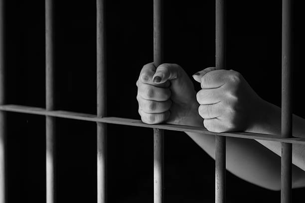 istock Woman hand in jail 502618638
