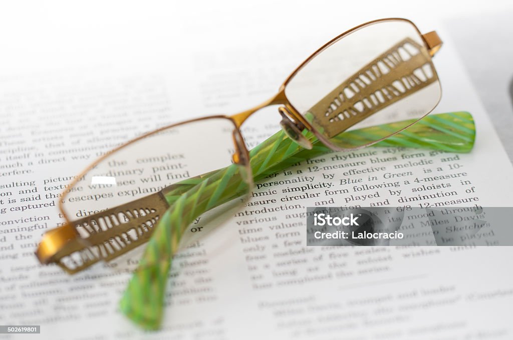 Reading Glasses over printed text. Miles Davis Stock Photo