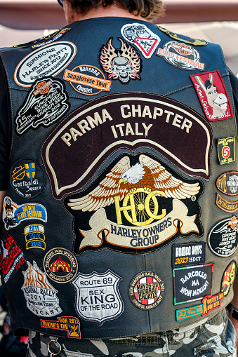 Barcelona, Spain - July 6, 2014: Unidentified persons with typical biker jacket a Harley Davidson motorbike at an exhibition during Barcelona Harley Days 2014. Distinctive groups and related associations.
