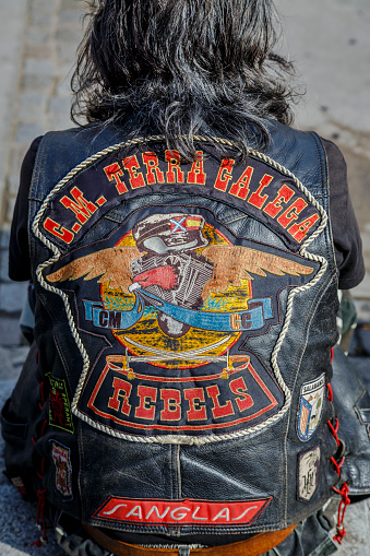 Barcelona, Spain - July 6, 2014: Unidentified persons with typical biker jacket a Harley Davidson motorbike at an exhibition during Barcelona Harley Days 2014. Distinctive groups and related associations.