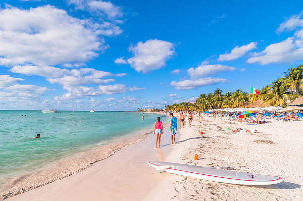 famous Playa del Norte beach in Isla Mujeres, Mexico Isla Mujeres, Mexico - April 21, 2014: tourists enjoy tropical sea on famous Playa del Norte beach in Isla Mujeres, Mexico. The island is located 8 miles northeast of Cancún in the Caribbean Sea. isla mujeres stock pictures, royalty-free photos & images