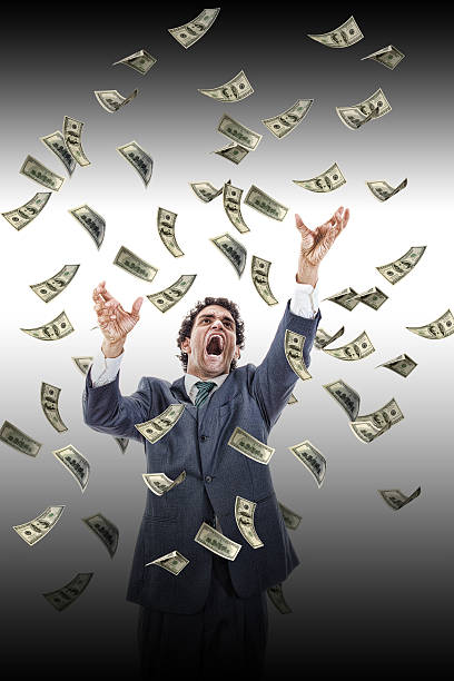 istock business man under falling money banknotes screaming reaching fo 502624719