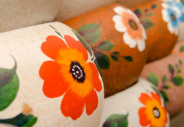 istock Mexican ceramic pots, rows of large orange flowers 502631438