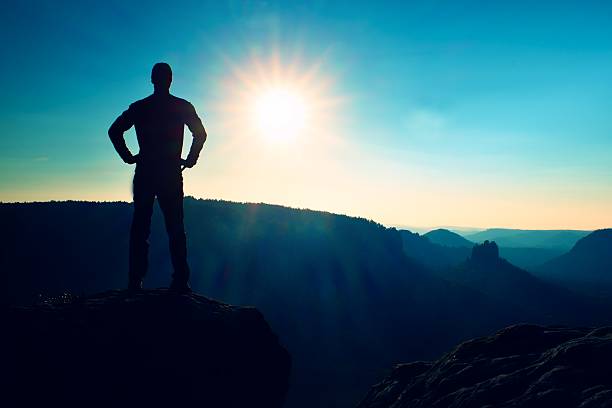 istock Tall man has hands on  hips. Sportsman silhouette at daybreak. 502632550