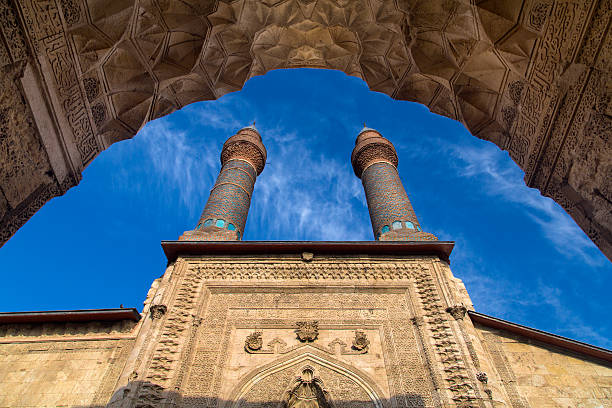 Double Minaret Madrasah and Sifaiye Madrasah The Cifte Minare Medrese (Double minaret Koran school) has been built in 1271. In its back a recent restoration shows the original ground plan, but it still is mainly important for its wonderful Seljuk façade.Sifaiye medrese is from 1217, inside is the tomb of Sultan Izzettin with fine caligraphic writing in tiles technique. The courtyard houses several teahouses, surrounded by many shops. The whole complex faces the Cifte Minaret medrese. madressa photos stock pictures, royalty-free photos & images