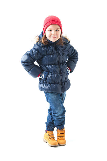 Cute little girl wearing winter clothes posing stock photo