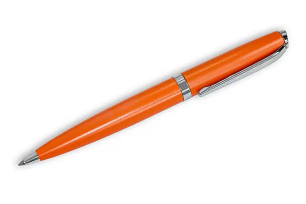 Orange ballpoint pen on white background.