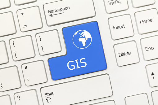 Close-up view on white conceptual keyboard - GIS (blue key)