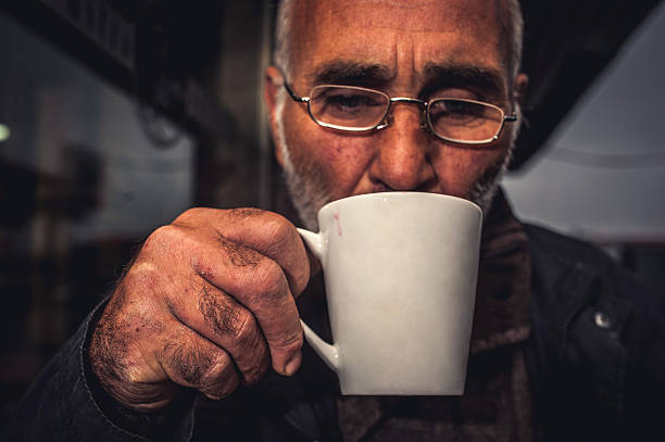 istock Senior Man Drinking Teain a Bar Outdoors at Night 502636864