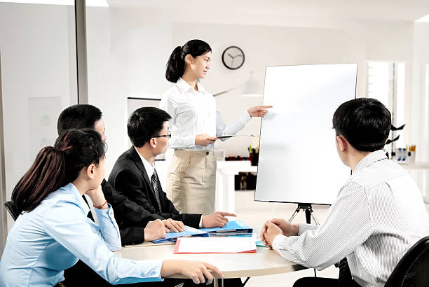 istock Group of business people looking at the graph on flipchart 502637464