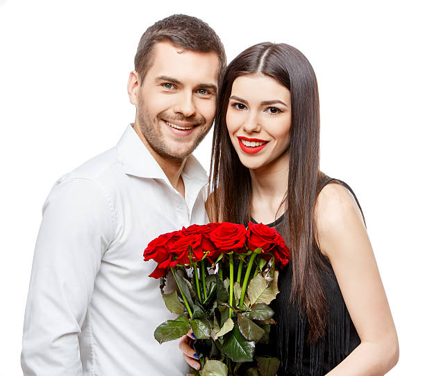 istock Young beautiful couple with flowers isolated on white 502639802