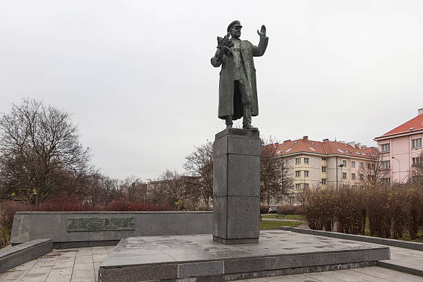 Prague, Czech Republic - December 20, 2015: The granite sculpture of a man in a coat and military cap and hand raised in greeting. The monument stands on a high granite pedestal. Nearby, on the low granite blocks stamped letters and numbers. The monument is located on the square, surrounded by bushes and trees. Author sculptor Zdenek Krybus. Established in 1980. Ivan Konev Stepanovich- Soviet military leader, Marshal of the Soviet Union. Troops under his command participated in the liberation of Prague from the Nazis. Marshal Konev Monument stands on the square Brigade in Prague 6.