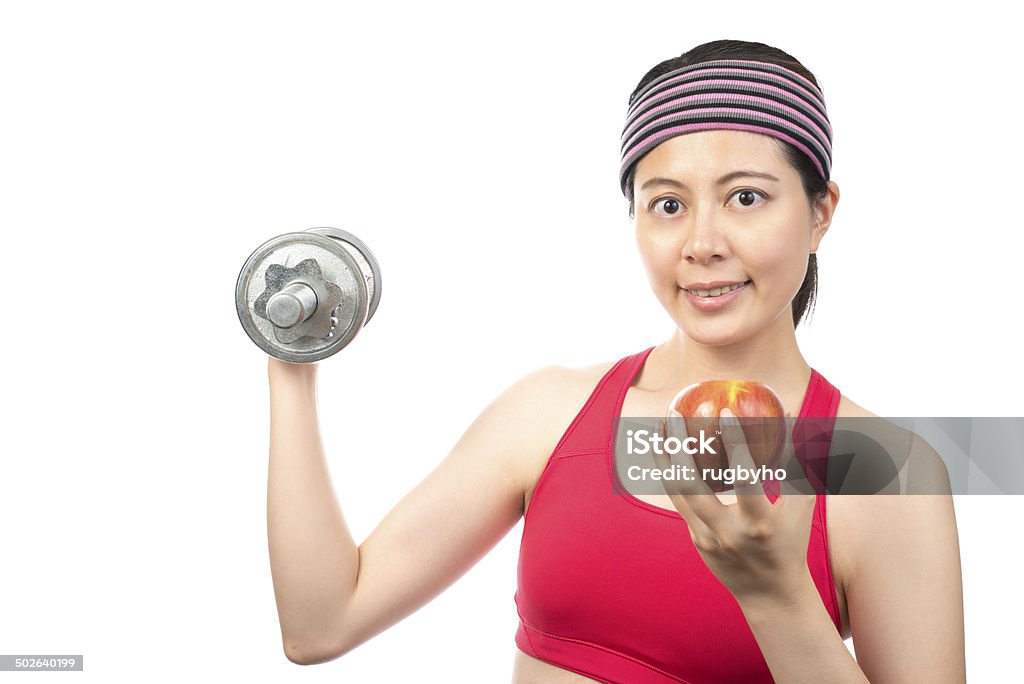 Healthy Lifestyle Smiling woman with heavy steel dumbbells and apple Abdomen Stock Photo