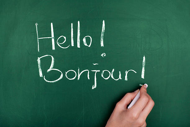 Hello! Hello! Woman hand writing ' Hello! Bonjour! ' on green blackboard french language photos stock pictures, royalty-free photos & images