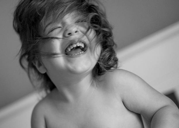 black and white portrait of a child in bed with his eyes open. the child is afraid of the bogeyman
