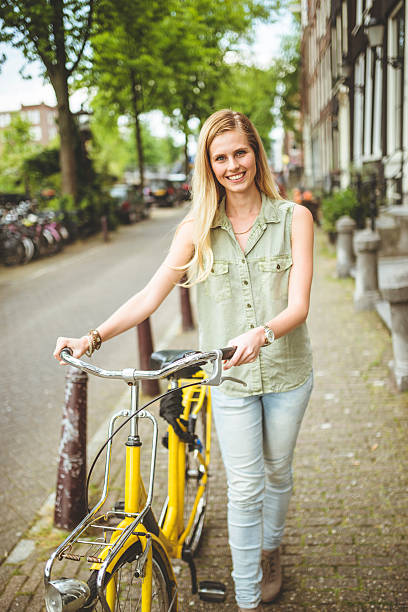 istock Dutch woman with bicycle in amsterdam walking 502641819
