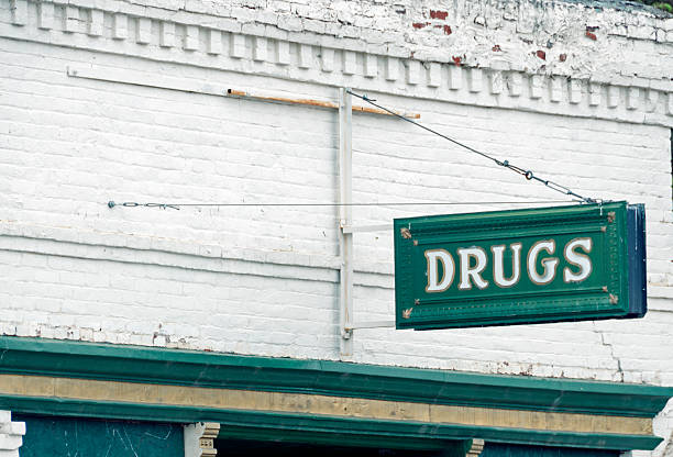 A workshop sign on a wrought iron bracket.