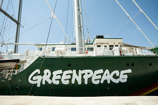 Greenpeace logo Zadar, Croatia - July 18, 2014: Greenpeace's Rainbow Warrior, an icon on the enviromental movement docked at Pier in Zadar, presentation solar and wind energy achievements.  greenpeace stock pictures, royalty-free photos & images