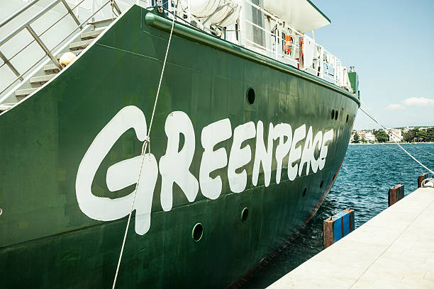 Greenpeace logo Zadar, Croatia - July 18, 2014: Greenpeace's Rainbow Warrior, an icon on the enviromental movement docked at Pier in Zadar, presentation of solar and wind energy achievements.  greenpeace stock pictures, royalty-free photos & images
