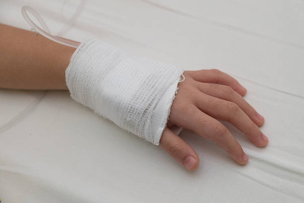 istock Kid's hand has a saline tube attached. 502644550