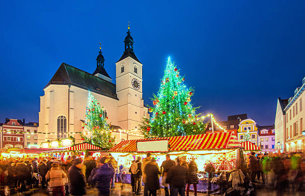 Regensburg´s Christmas Market with food and christmas decoration stalls around the 500-year-old Neupfarr Church and beautiful town houses.