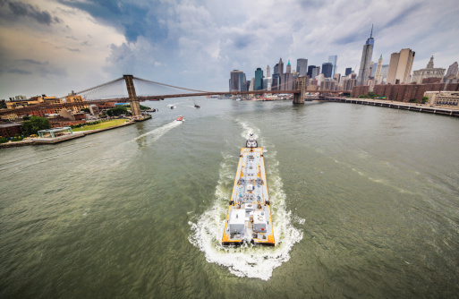 Industrial ship at the East River between Brooklyn Bridge and Manhattan Bridge. New York City, USA. View from the Manhattan Bridge 