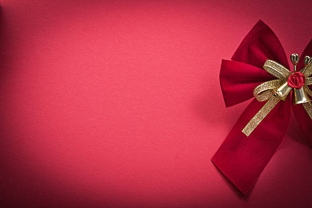 istock Christmas knot with bells on red background holidays concept 502645786