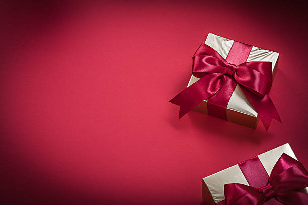 istock Golden present boxes on red background holidays concept 502646554