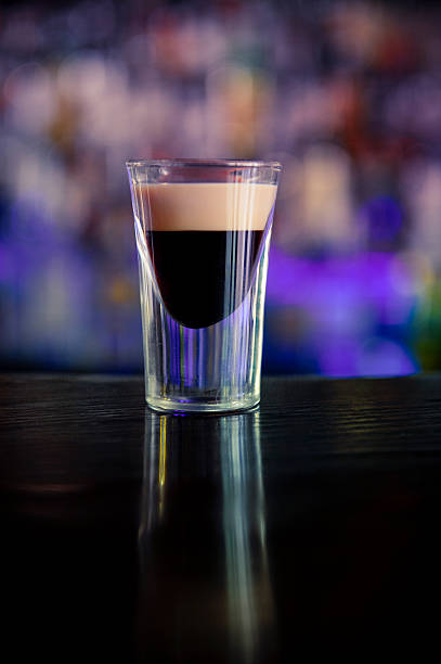 Baby Guinness shot Shot glass with Kahlua coffee liqueur flavor. With  Irish cream on top. coffee liqueur stock pictures, royalty-free photos & images