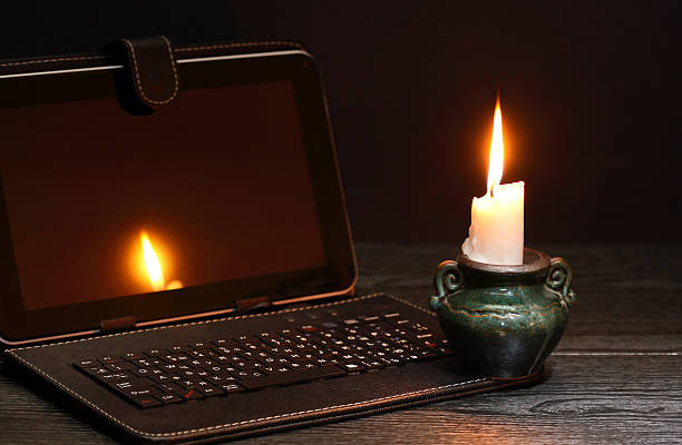 Candle Near Laptop stock photo