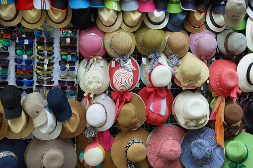 Peru, Lima - April 19, 2015: View of a market stall with colorful hats and glasses in Lima, Peru.