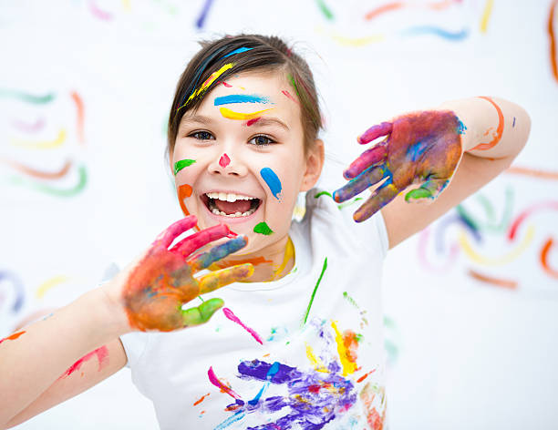 istock Cute girl playing with paints 502660386