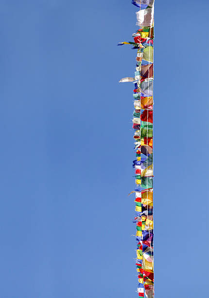 istock Prayer flags of different colors on blue sky 502660563