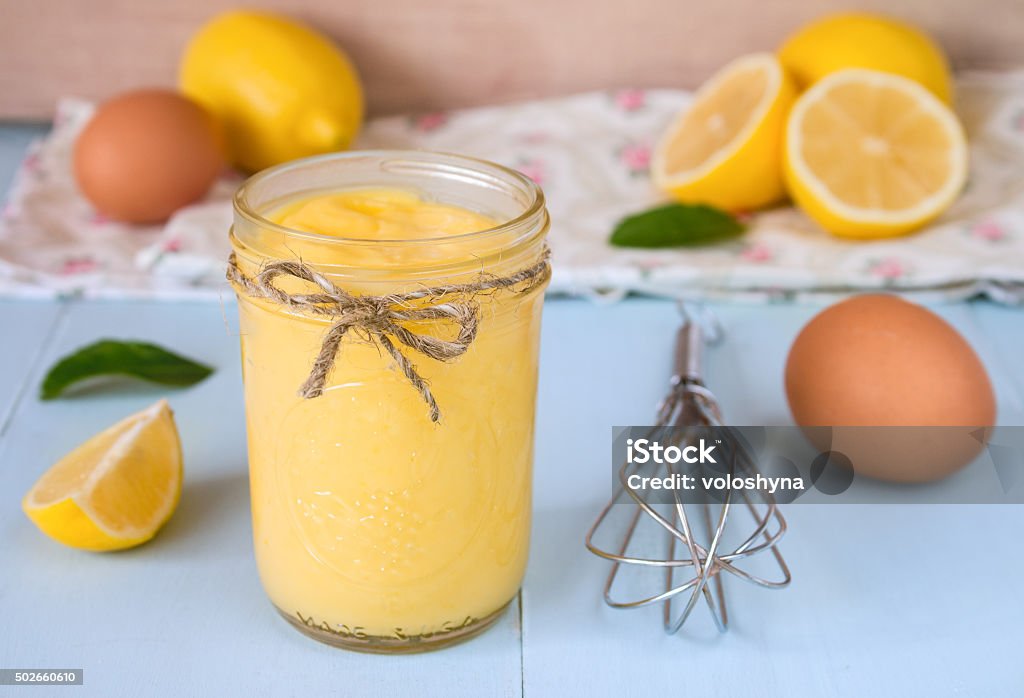 Lemon Curd Lemon curd on a blue background Lemon Custard Stock Photo