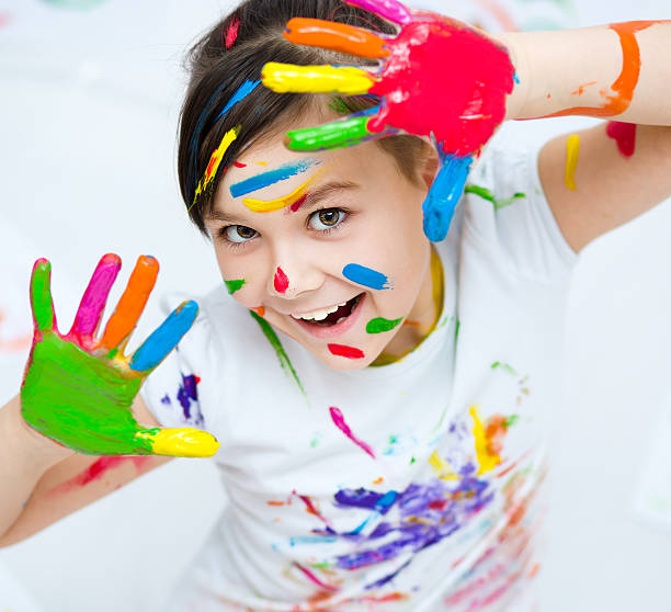 istock Cute girl playing with paints 502660686