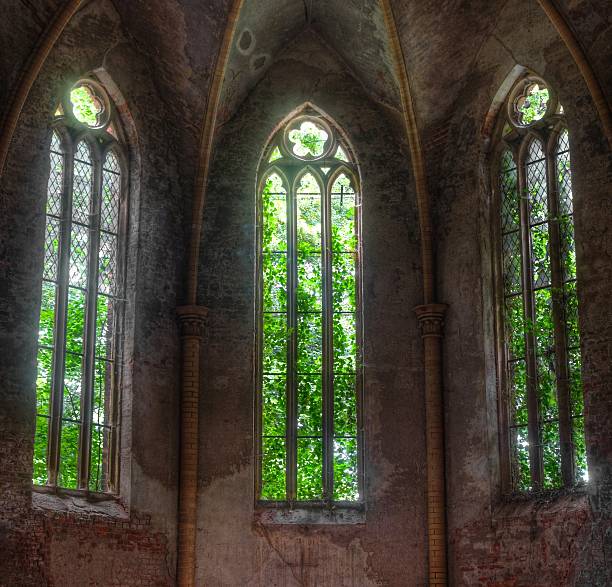 istock Church window overgrown in ailing Church 502660845
