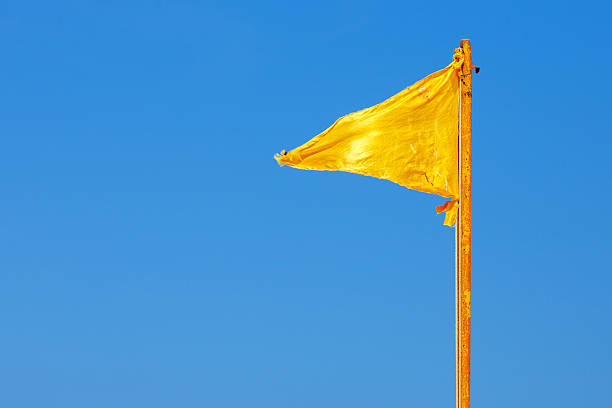 istock Yellow flag and blue sky 502661045