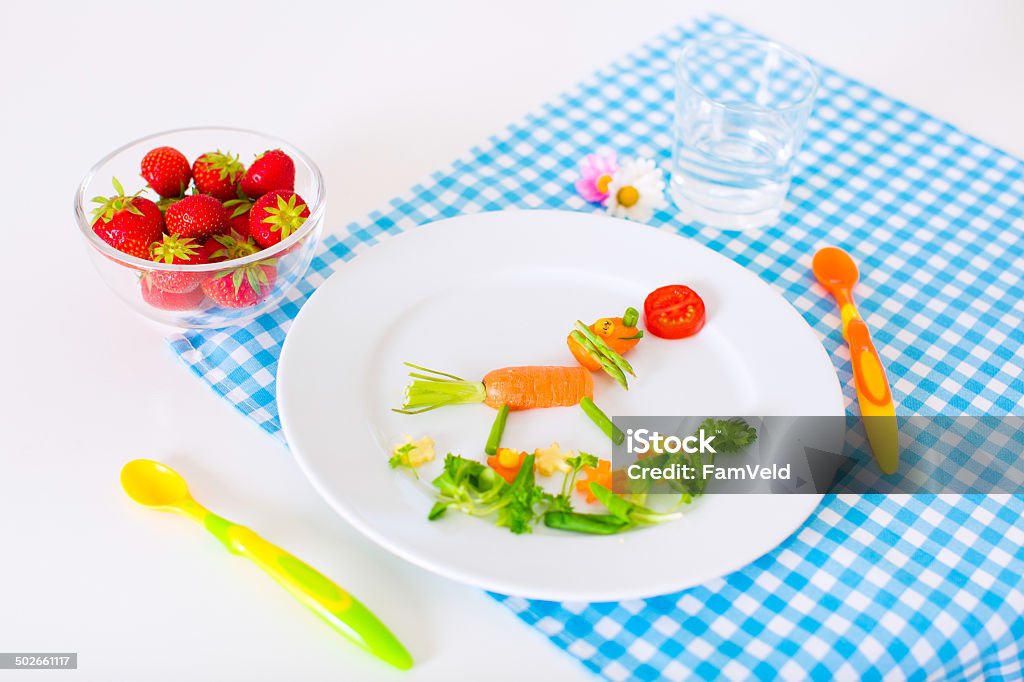 Healthy vegetarian lunch for little kids, vegetables and fruits Healthy vegetarian lunch for little kids, vegetables and fruit served as animals, corn, broccoli, carrots and fresh strawberry helping children to learn eating right and clean Animal Stock Photo