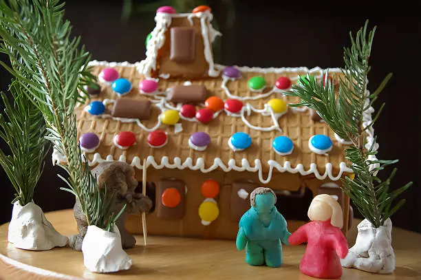 marzipan Hansel and Gretel with gingerbread house and witch in forest