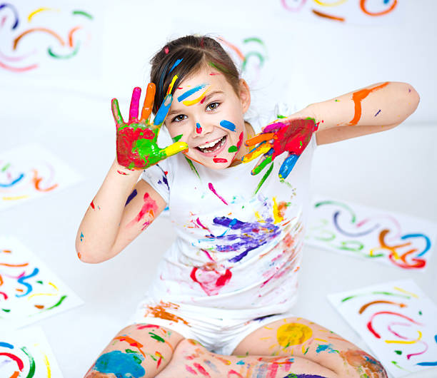 istock Cute girl playing with paints 502661372