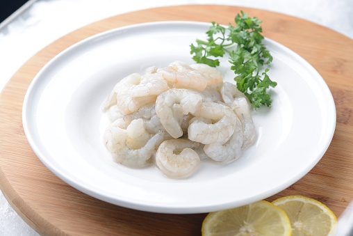 raw peel prawns in a white bowl without a marinate