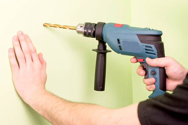 istock Holding  in hands Electric drills 502664284