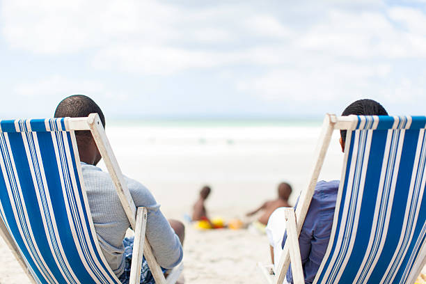 istock African couple watching their sons at the beach 502664993