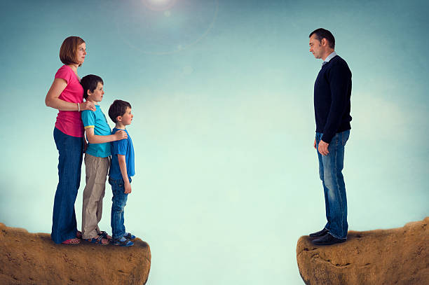 a   family, middle-aged husband and wife, young son and teenage daughter, sitting on sofa, studio photo shoot