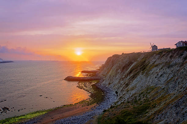 istock sunset on the sea with Aixerrota mill 502666473