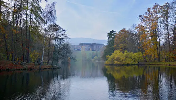 The photo shows the Schloss Wilhelmshöhe in Kassel on an early and foggy sunday morning. Thereby the palace is mirrored in the subjacent lake.