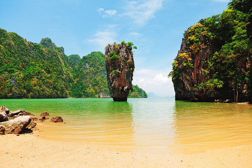 Khao Phing Kan is a pair of islands on the west coast of Thailand, in the Phang Nga Bay, Andaman Sea, near Phuket. About 40 metres from its shores lies a 20 meters tall islet Ko Tapu or Khao Tapu. The island is a part of the Ao Phang Nga National Park. Since 1974, when it was featured in the James Bond movie The Man with the Golden Gun, it is popularly called James Bond Island.