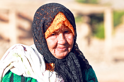 Fes, Morocco - October 19, 2013: An old bedouin woman in the desert from Morocco.